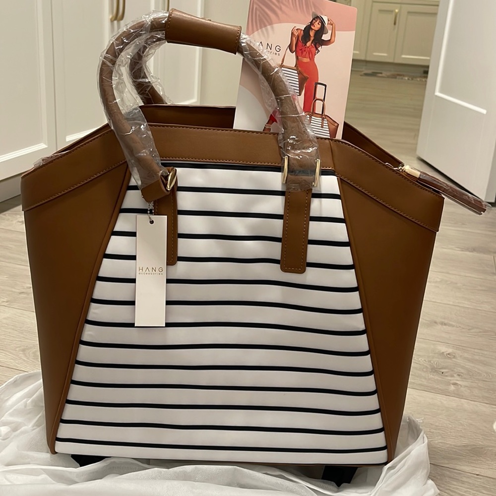 Carry-on luggage. La Vie Carry-on Rolling Tote from Hang Accessories. NWT.